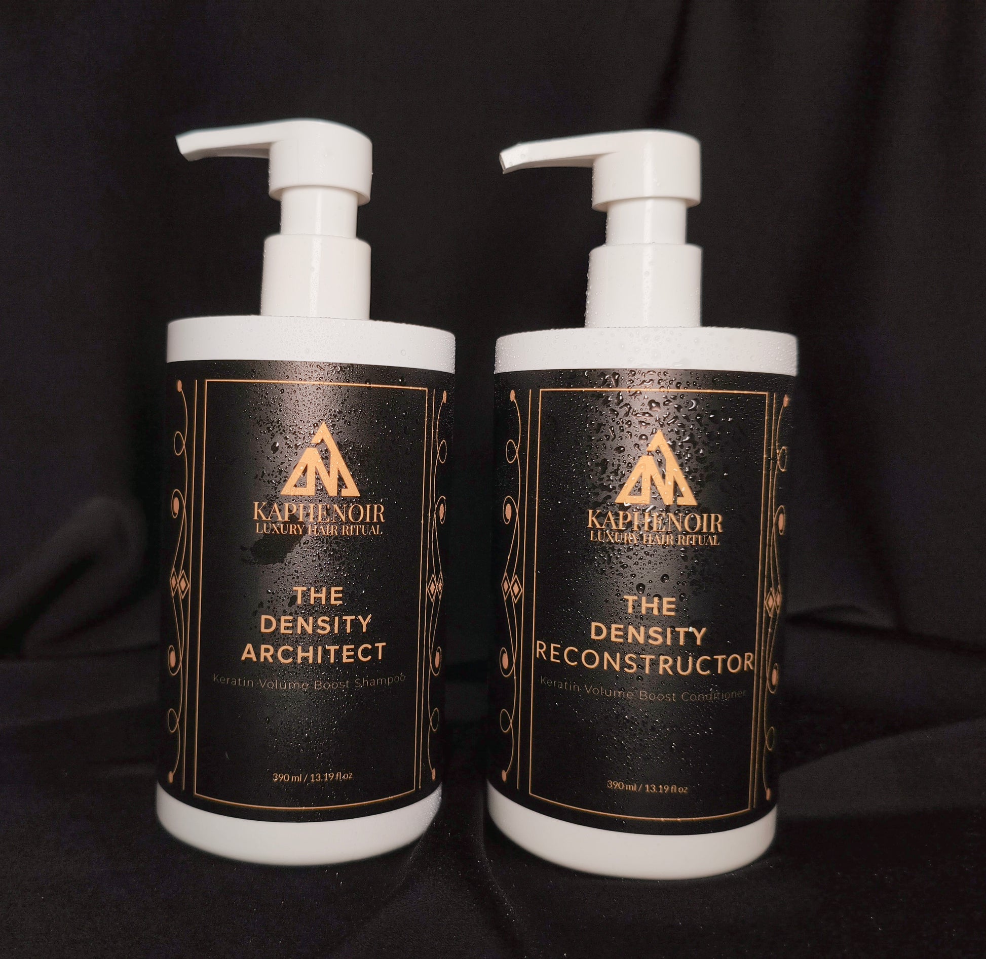 KapheNoir Density Architect shampoo and Density Reconstructor conditioner bottles on black fabric backdrop