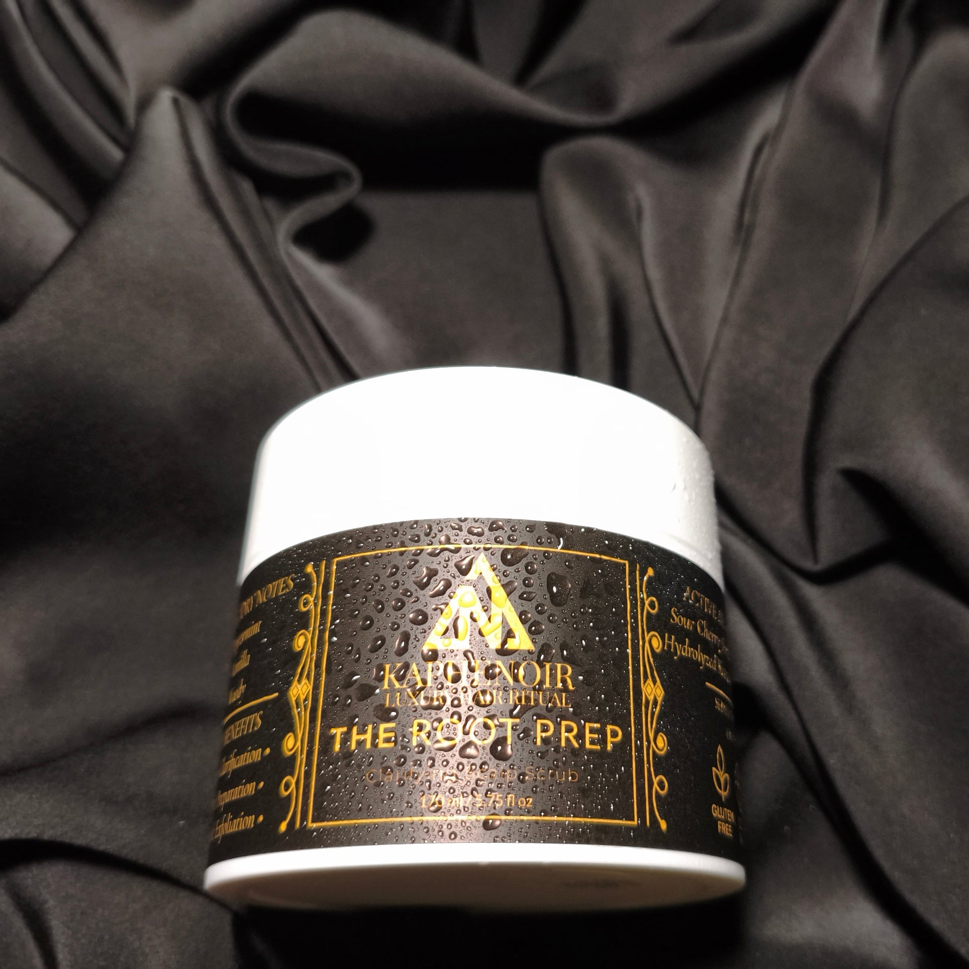 KapheNoir hair product jar labeled 'The Root Prep' on black fabric